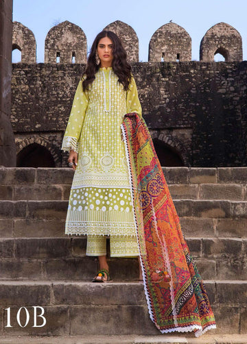 A woman wearing a traditional, embroidered chikankari suit in yellow with a red and multicolor dupatta, standing in front of a historic building with stone arches.